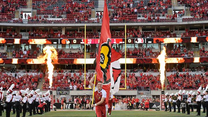 Sep 16, 2022; Louisville, Kentucky, USA; ALouisville Cardinals cheerleader carries a flag down the field before the first half against the Florida State Seminoles at Cardinal Stadium. Florida State defeated Louisville 35-31. Mandatory Credit: Jamie Rhodes-USA TODAY Sports Sep 16, 2022; Louisville, Kentucky, USA; ALouisville Cardinals cheerleader carries a flag down the field before the first half against the Florida State Seminoles at Cardinal Stadium. Florida State defeated Louisville 35-31. Mandatory Credit: Jamie Rhodes-USA TODAY Sports