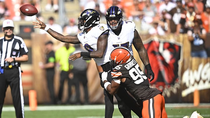 Oct 1, 2023; Cleveland, Ohio, USA; Baltimore Ravens quarterback Lamar Jackson (8) throws a pass as he is hit by Cleveland Browns defensive end Myles Garrett (95) in the third quarter at Cleveland Browns Stadium. Mandatory Credit: David Richard-Imagn Images Oct 1, 2023; Cleveland, Ohio, USA; Baltimore Ravens quarterback Lamar Jackson (8) throws a pass as he is hit by Cleveland Browns defensive end Myles Garrett (95) in the third quarter at Cleveland Browns Stadium. Mandatory Credit: David Richard-Imagn Images