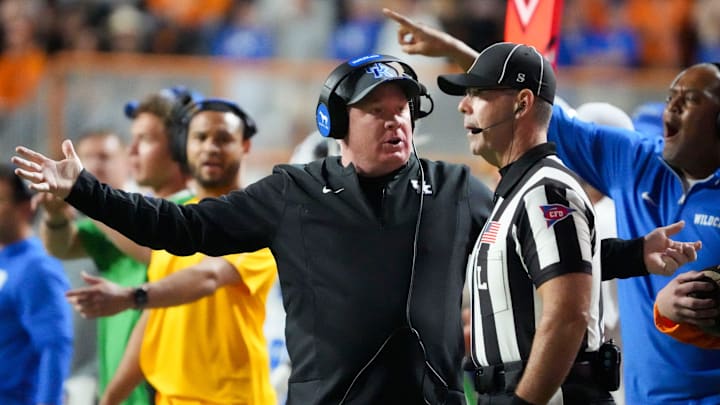 Kentucky football coach Mark Stoops talks with an official during an NCAA college football game between Tennessee and Kentucky on Saturday, Nov. 2, 2024, in Knoxville, Tenn.
