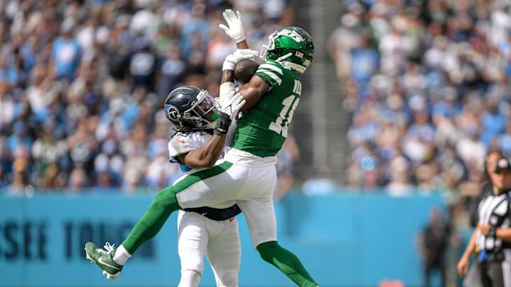Sep 15, 2024; Nashville, Tennessee, USA;  New York Jets wide receiver Allen Lazard (10) makes a catch over Tennessee Titans cornerback Roger McCreary (21) during the second half at Nissan Stadium. 