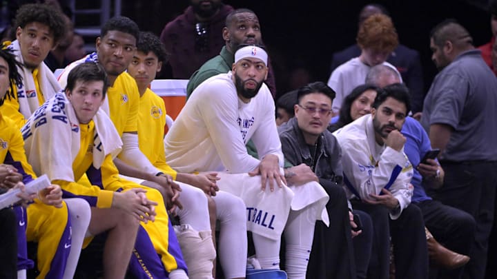 Jan 23, 2024; Los Angeles, California, USA; Los Angeles Lakers guard Jalen Hood-Schifino (0) and guard Austin Reaves (15) and forward Rui Hachimura (28) and guard Max Christie (10) forward Anthony Davis (3) and forward LeBron James (23) look on from the bench in the second half against the Los Angeles Clippers at Crypto.com Arena. Mandatory Credit: Jayne Kamin-Oncea-Imagn Images