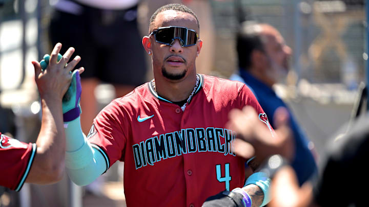 Aug 31, 2025; Los Angeles, California, USA;  Arizona Diamondbacks second baseman Ketel Marte (4) is greeted in the dugout after scoring a run during the fourth inning against the Los Angeles Dodgers at Dodger Stadium. Mandatory Credit: Jayne Kamin-Oncea-Imagn Images