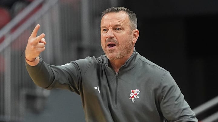 Louisville's head coach Jeff Walz talks to his players against Ball State in KFC Yum! Center Wednesday night