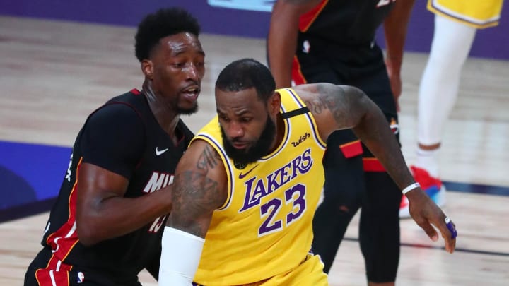 Sep 30, 2020; Orlando, Florida, USA; Los Angeles Lakers forward LeBron James (23) handles the ball against Miami Heat forward Bam Adebayo (13) during the first quarter in game one of the 2020 NBA Finals at AdventHealth Arena. Mandatory Credit: Kim Klement-USA TODAY Sports