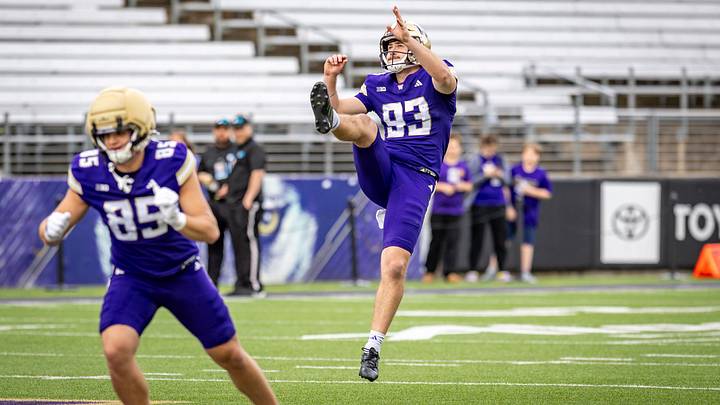 Hunter Green gets airborne as he launches a Spring Game punt. 