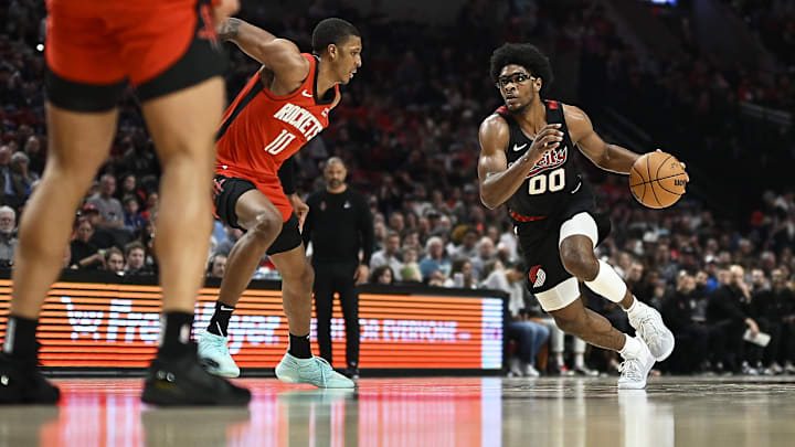 Apr 12, 2024; Portland, Oregon, USA; Portland Trail Blazers guard Scoot Henderson (00) drives to the basket during the second half against Houston Rockets forward Jabari Smith Jr. (10) at Moda Center. Mandatory Credit: Troy Wayrynen-Imagn Images
