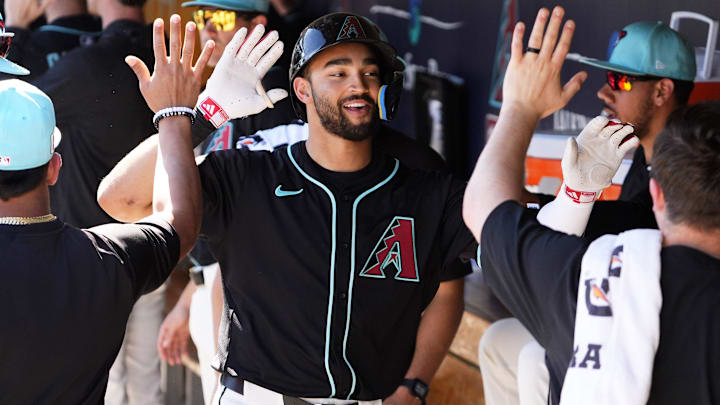 Arizona Diamondbacks Jordan Lawlar receives high-fives in the dugout after hitting a two-run home run off Milwaukee Brewers pitcher Tyler Alexander in the second inning of a spring training game at Salt River Fields at Talking Stick in Scottsdale, Ariz., on Feb. 26, 2025.