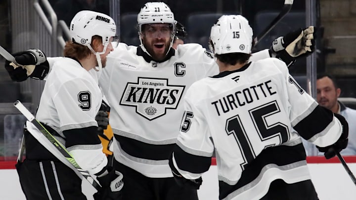 Dec 17, 2024; Pittsburgh, Pennsylvania, USA;  Los Angeles Kings right wing Adrian Kempe (9) celebrates after scoring a goal with center Anze Kopitar (11) and center Alex Turcotte (15) during the first period against the Pittsburgh Penguins at PPG Paints Arena. Mandatory Credit: Charles LeClaire-Imagn Images