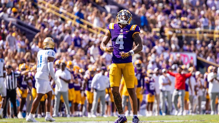 Sep 21, 2024; Baton Rouge, Louisiana, USA;  LSU Tigers wide receiver CJ Daniels (4) reacts after missing a pass against UCLA Bruins defensive back Ramon Henderson (11) during the first half at Tiger Stadium. Mandatory Credit: Stephen Lew-Imagn Images