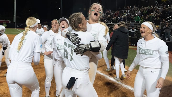 A jubilant Oregon squad celebrates after their 10-7 comeback win over Stanford Sunday at Jane Sanders Stadium. Oregon wrested a pair from the The Cardinal to earn a host berth in Super Regional round of the NCAA Softball Tournament.
