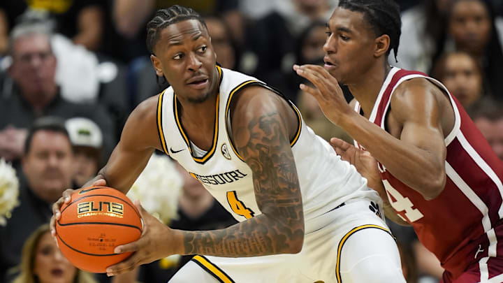 Feb 12, 2025; Columbia, Missouri, USA; Missouri Tigers guard Marcus Allen (4) looks to pass against Oklahoma Sooners forward Jalon Moore (14) during the second half at Mizzou Arena. Mandatory Credit: Jay Biggerstaff-Imagn Images