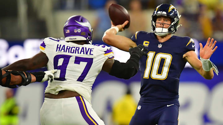 Oct 23, 2025; Inglewood, California, USA; Minnesota Vikings defensive tackle Javon Hargrave (97) gets pressure on Los Angeles Chargers quarterback Justin Herbert (10) during the first half at SoFi Stadium.