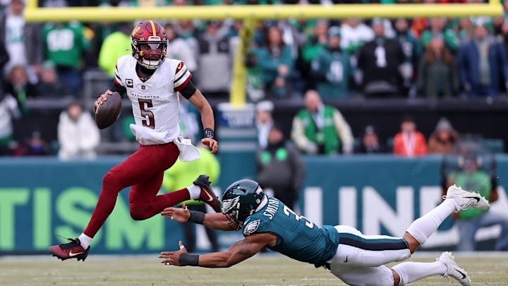 Jan 26, 2025; Philadelphia, PA, USA; Washington Commanders quarterback Jayden Daniels (5) leaps to avoid the tackle of Philadelphia Eagles linebacker Nolan Smith Jr. (3) during the first half of the NFC Championship game at Lincoln Financial Field. Mandatory Credit: Bill Streicher-Imagn Images Jan 26, 2025; Philadelphia, PA, USA; Washington Commanders quarterback Jayden Daniels (5) leaps to avoid the tackle of Philadelphia Eagles linebacker Nolan Smith Jr. (3) during the first half of the NFC Championship game at Lincoln Financial Field. Mandatory Credit: Bill Streicher-Imagn Images