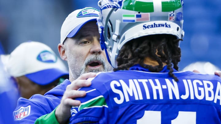 Oct 10, 2024; Seattle, Washington, USA; Seattle Seahawks offensive coordinator Ryan Grubb talks with wide receiver Jaxon Smith-Njigba (11) during pregame warmups against the San Francisco 49ers at Lumen Field. Mandatory Credit: Joe Nicholson-Imagn Images