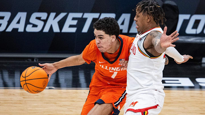 Mar 14, 2025; Indianapolis, IN, USA; Illinois Fighting Illini forward Will Riley (7) dribbles the ball while Maryland Terrapins guard DeShawn Harris-Smith (5) defends in the first half  at Gainbridge Fieldhouse. Mandatory Credit: Trevor Ruszkowski-Imagn Images