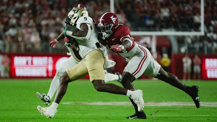 Sep 7, 2024; Tuscaloosa, Alabama, USA;  Alabama Crimson Tide linebacker Justin Jefferson (15) dives for South Florida Bulls running back Ta'Ron Keith (9) as he runs the ball down the field during the fourth quarter at Bryant-Denny Stadium. Mandatory Credit: William McLelland-Imagn Images