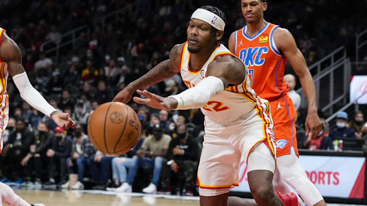 Former Atlanta Hawks forward Cam Reddish (22) reaches for the ball after a steal from Oklahoma City Thunder forward Darius Bazley (7) during the first half at State Farm Arena.