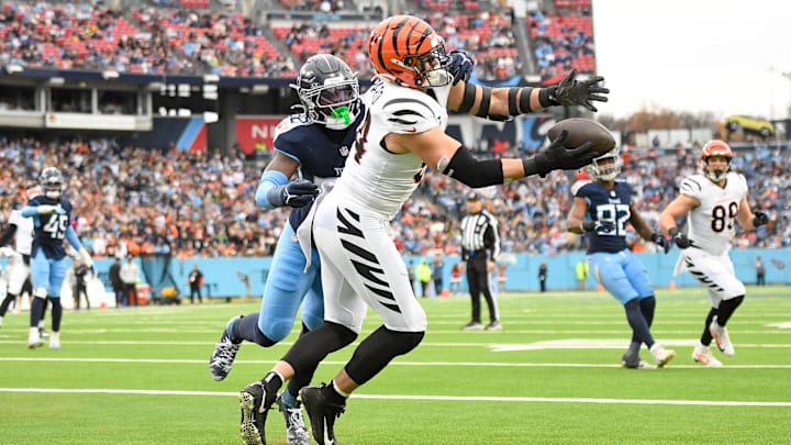 Dec 15, 2024; Nashville, Tennessee, USA; Cincinnati Bengals defensive end Sam Hubbard (94) makes a touchdown catch over Tennessee Titans linebacker James Williams (52) during the first half at Nissan Stadium. Mandatory Credit: Steve Roberts-Imagn Images Dec 15, 2024; Nashville, Tennessee, USA; Cincinnati Bengals defensive end Sam Hubbard (94) makes a touchdown catch over Tennessee Titans linebacker James Williams (52) during the first half at Nissan Stadium. Mandatory Credit: Steve Roberts-Imagn Images