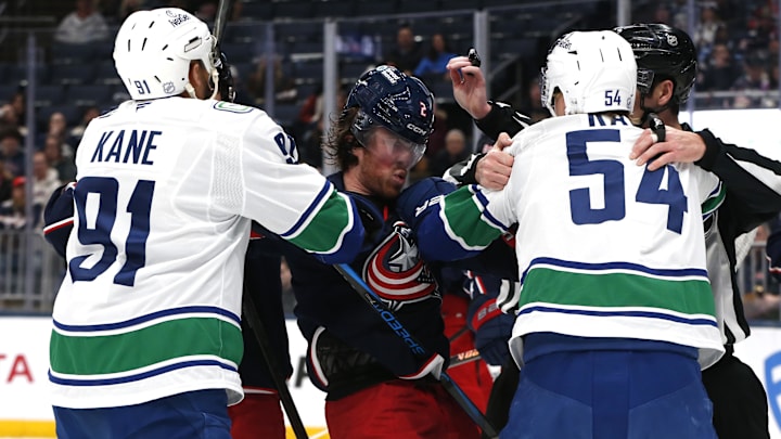 Jan 15, 2026; Columbus, Ohio, USA; Columbus Blue Jackets defenseman Jake Christiansen (2) scrums with Vancouver center Aatu Raty (54) and left wing Evander Kane (91) during the first period at Nationwide Arena. Mandatory Credit: Russell LaBounty-Imagn Images