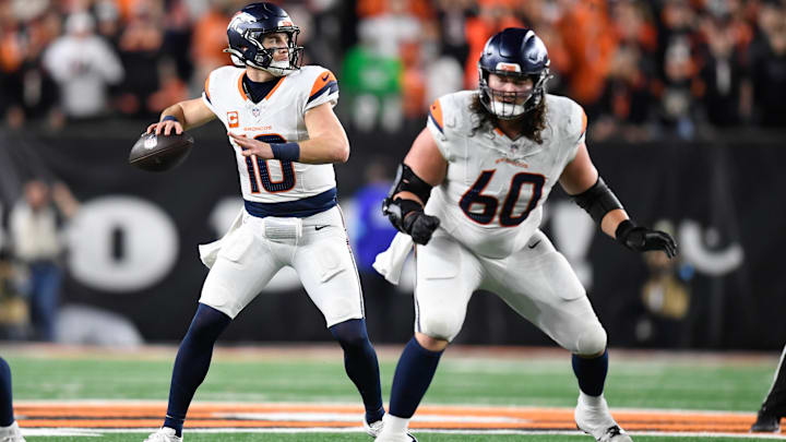 CINCINNATI, OH - DECEMBER 28: Denver Broncos Quarterback Bo Nix (10) passes as Denver Broncos Center Luke Wattenberg (60) blocks during the NFL, American Football Herren, USA football game between the Denver Broncos and the Cincinnati Bengals on December 28, 2024, at Paycor Stadium in Cincinnati, Ohio.
