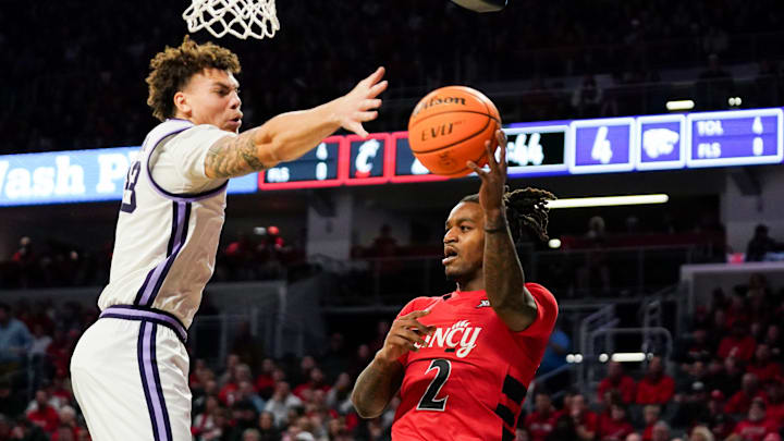Cincinnati Bearcats guard Jizzle James (2) makes a pass in the first half of a NCAA men’s basketball game between the Cincinnati Bearcats and Kansas State Wildcats, Wednesday, March 5, 2025, at Fifth Third Arena in Cincinnati.