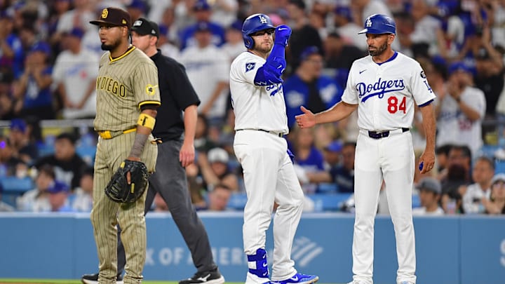 Jun 17, 2025; Los Angeles, California, USA; Los Angeles Dodgers third baseman Max Muncy (13) reaches first on a single against the San Diego Padres during the sixth inning at Dodger Stadium. Mandatory Credit: Gary A. Vasquez-Imagn Images