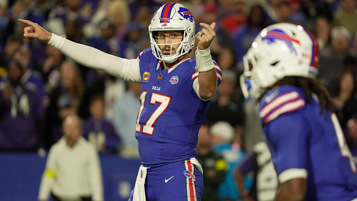 Buffalo Bills QB Josh Allen signals to running back James Cook during first-half action against the Baltimore Ravens.