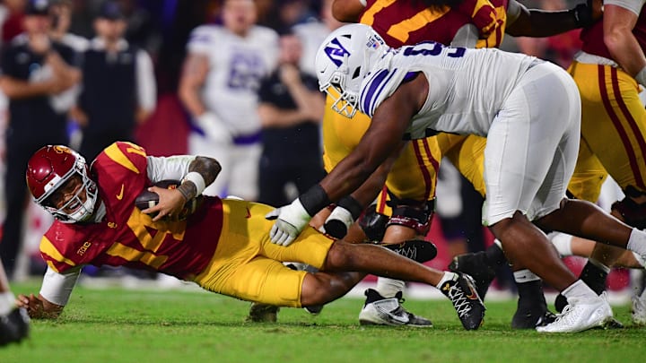 Nov 7, 2025; Los Angeles, California, USA; Southern California Trojans quarterback Jayden Maiava (14) falls as Northwestern Wildcats defensive lineman Najee Story (95) moves in during the first half at the Los Angeles Memorial Coliseum. Mandatory Credit: Gary A. Vasquez-Imagn Images Nov 7, 2025; Los Angeles, California, USA; Southern California Trojans quarterback Jayden Maiava (14) falls as Northwestern Wildcats defensive lineman Najee Story (95) moves in during the first half at the Los Angeles Memorial Coliseum. Mandatory Credit: Gary A. Vasquez-Imagn Images