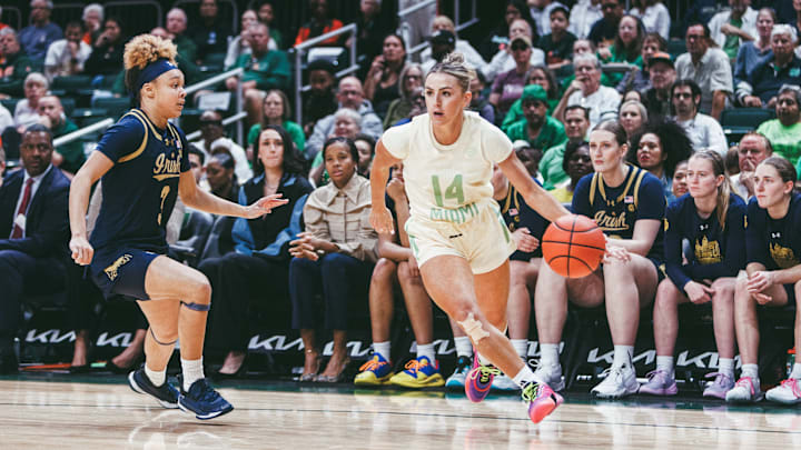 Miami's Haley Cavinder (14) driving the basketball inside the paint against Notre Dame's Hannah Hidalgo (3) at the Watsco Center Miami's Haley Cavinder (14) driving the basketball inside the paint against Notre Dame's Hannah Hidalgo (3) at the Watsco Center