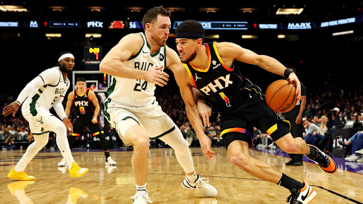Feb 6, 2024; Phoenix, Arizona, USA; Phoenix Suns guard Devin Booker (1) drives to the basket against Milwaukee Bucks guard Pat Connaughton (24) during the third quarter at Footprint Center.