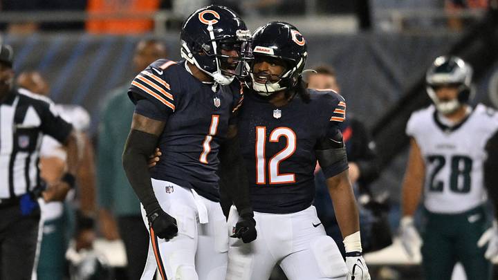 Chicago Bears defensive back Jaylon Johnson (1) reacts with linebacker Devin Bush (12) during the second half against the Philadelphia Eagles at Soldier Field.  Mandatory Credit: Patrick Gorski-Imagn Images