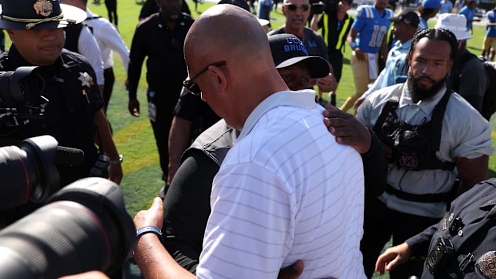 UCLA Bruins interim head coach Tim Skipper (black cap) hugs Penn State Nittany Lions head coach James Franklin after defeating the Penn State 42-37 at the Rose Bowl. 