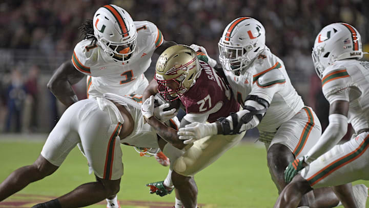Oct 4, 2025; Tallahassee, Florida, USA; Miami Hurricanes defensive lineman Rueben Bain Jr. (4) tackles Florida State Seminoles running back Gavin Sawchuk (27) during the first half at Doak S. Campbell Stadium. Mandatory Credit: Melina Myers-Imagn Images Oct 4, 2025; Tallahassee, Florida, USA; Miami Hurricanes defensive lineman Rueben Bain Jr. (4) tackles Florida State Seminoles running back Gavin Sawchuk (27) during the first half at Doak S. Campbell Stadium. Mandatory Credit: Melina Myers-Imagn Images