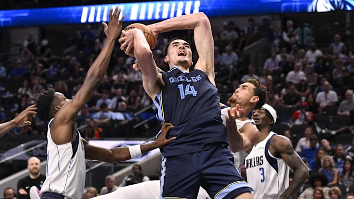 Dallas Mavericks center Dwight Powell (7) blocks a shot by Memphis Grizzlies center Zach Edey (14) during the second half at the American Airlines Center. Mandatory Credit: Jerome Miron-Imagn Images
