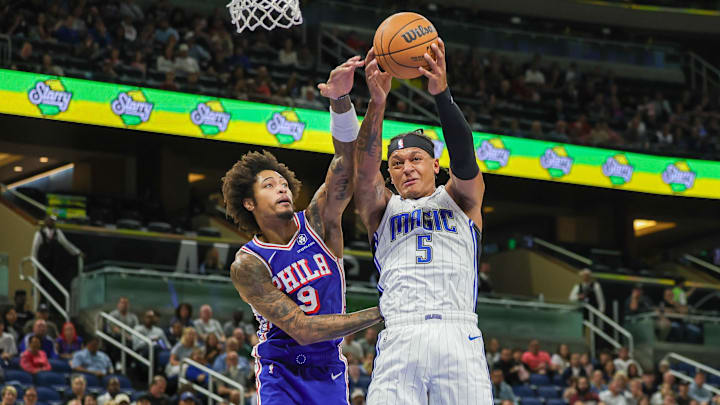 Orlando Magic forward Paolo Banchero (5) grabs the rebound against Philadelphia 76ers guard Kelly Oubre Jr. (9) during the first quarter at Kia Center.