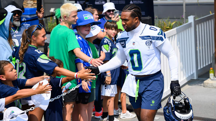Jul 27, 2024; Renton, WA, USA; Seattle Seahawks linebacker Tyrel Dodson (0) interacts with fans before training camp at Virginia Mason Athletic Center. Mandatory Credit: Steven Bisig-Imagn Images Jul 27, 2024; Renton, WA, USA; Seattle Seahawks linebacker Tyrel Dodson (0) interacts with fans before training camp at Virginia Mason Athletic Center. Mandatory Credit: Steven Bisig-Imagn Images