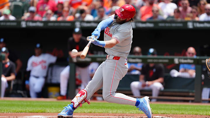 Jun 16, 2024; Baltimore, Maryland, USA; Philadelphia Phillies first baseman Bryce Harper (3) hits a single against the Baltimore Orioles during the first inning at Oriole Park at Camden Yards. Jun 16, 2024; Baltimore, Maryland, USA; Philadelphia Phillies first baseman Bryce Harper (3) hits a single against the Baltimore Orioles during the first inning at Oriole Park at Camden Yards.