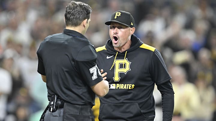May 30, 2025; San Diego, California, USA; Pittsburgh Pirates manager Don Kelly (12) yells at umpire Edward Jimenez (75) during the eighth inning against the San Diego Padres at Petco Park. Mandatory Credit: Denis Poroy-Imagn Images