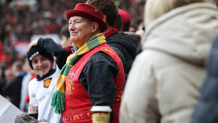 Manchester United fans can always be seen with a green and gold scarf Manchester United fans can always be seen with a green and gold scarf