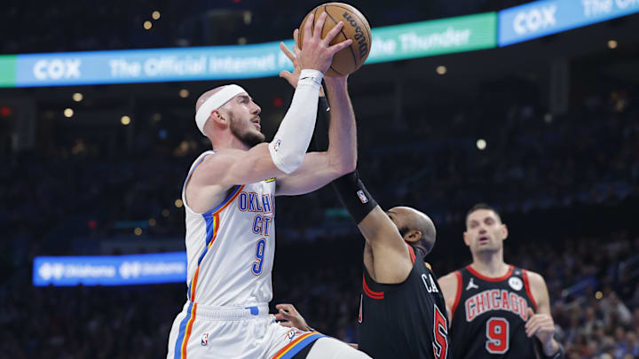 Mar 31, 2025; Oklahoma City, Oklahoma, USA; Oklahoma City Thunder guard Alex Caruso (9) goes up for a basket as Chicago Bulls guard Jevon Carter (5) defends during the second quarter at Paycom Center. Mandatory Credit: Alonzo Adams-Imagn Images Mar 31, 2025; Oklahoma City, Oklahoma, USA; Oklahoma City Thunder guard Alex Caruso (9) goes up for a basket as Chicago Bulls guard Jevon Carter (5) defends during the second quarter at Paycom Center. Mandatory Credit: Alonzo Adams-Imagn Images