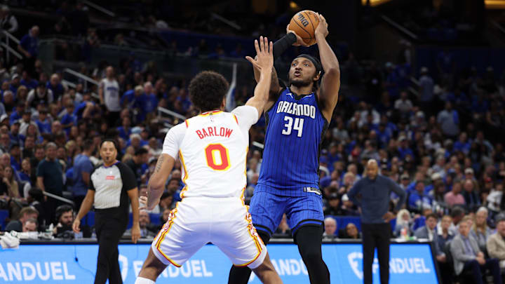 Apr 15, 2025; Orlando, Florida, USA; Orlando Magic center Wendell Carter Jr. (34) shoots the ball over Atlanta Hawks forward Dominick Barlow (0) in the fourth quarter at Kia Center. Mandatory Credit: Nathan Ray Seebeck-Imagn Images
