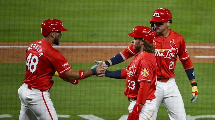 May 23, 2025; St. Louis, Missouri, USA;  St. Louis Cardinals designated hitter Ivan Herrera (48) right fielder Lars Nootbaar (21) and left fielder Brendan Donovan (33) celebrate after they scored on a three run triple by third baseman Nolan Arenado (not pictured) during the sixth inning against the Arizona Diamondbacks at Busch Stadium. Mandatory Credit: Jeff Curry-Imagn Images