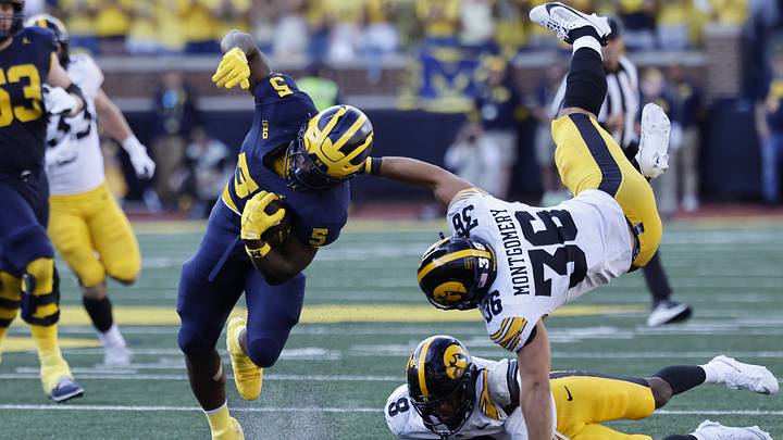 Sep 26, 2026; Ann Arbor, Michigan, USA; Michigan Wolverines running back Savion Hiter (5) runs against Iowa Hawkeyes linebacker Jayden Montgomery (36) during the second half at Michigan Stadium. Mandatory Credit: Rick Osentoski-Imagn Images Sep 26, 2026; Ann Arbor, Michigan, USA; Michigan Wolverines running back Savion Hiter (5) runs against Iowa Hawkeyes linebacker Jayden Montgomery (36) during the second half at Michigan Stadium. Mandatory Credit: Rick Osentoski-Imagn Images