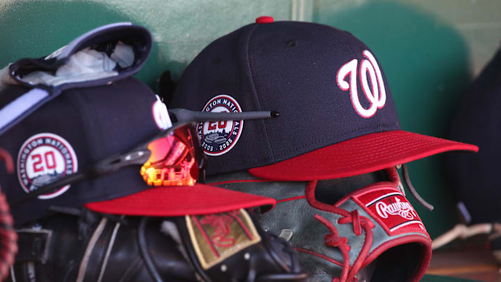Apr 17, 2025; Pittsburgh, Pennsylvania, USA; Washington Nationals hats and gloves in the dugout against the Pittsburgh Pirates during the sixth inning at PNC Park. 