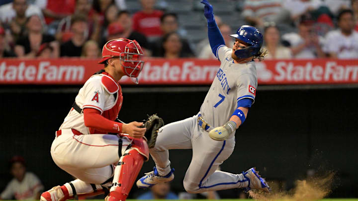 Sep 23, 2025; Anaheim, California, USA;  Kansas City Royals shortstop Bobby Witt Jr. (7) beats the throw to Los Angeles Angels catcher Logan O'Hoppe (14) as he scored on a single by catcher Salvador Perez (13) during the first inning at Angel Stadium. Mandatory Credit: Jayne Kamin-Oncea-Imagn Images