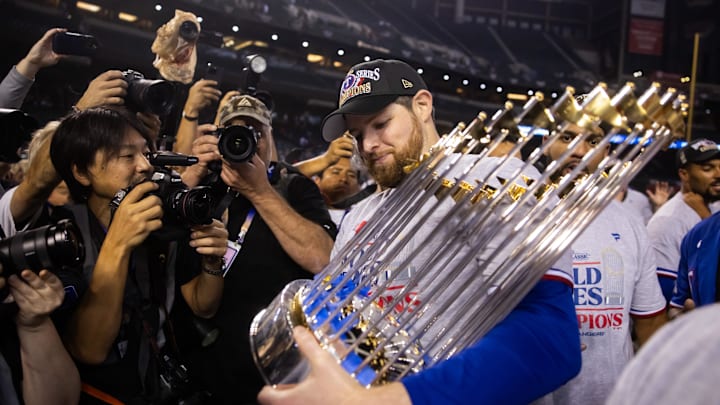 Nov 1, 2023; Phoenix, Arizona, USA; Texas Rangers  pitcher Jordan Montgomery (52) celebrates with the trophy after winning the 2023 World Series in game five against the Arizona Diamondbacks at Chase Field. Mandatory Credit: Mark J. Rebilas-Imagn Images