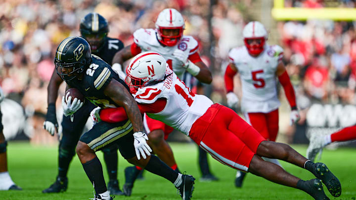 Sep 28, 2024; West Lafayette, Indiana, USA; Purdue Boilermakers running back Reggie Love III (23) is tackled by Nebraska Cornhuskers linebacker Princewill Umanmielen (18) during the second half at Ross-Ade Stadium. Mandatory Credit: Marc Lebryk-Imagn Images