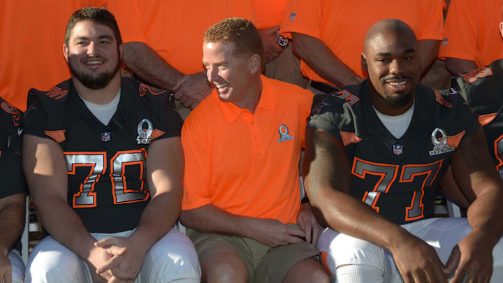 Jan 23, 2015; Phoenix, AZ, USA; Dallas Cowboys guard Zack Martin (70), coach Jason Garrett (center) and tackle Tyron Smith (77) pose during team photos for the 2015 Pro Bowl at The Arizona Biltmore. Mandatory Credit: Kirby Lee-Imagn Images