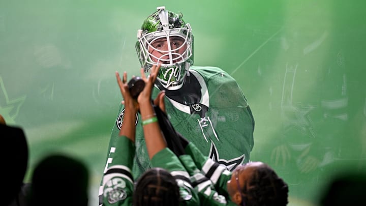 Oct 28, 2025; Dallas, Texas, USA; Dallas Stars goaltender Jake Oettinger (29) tosses a puck into the crowd after being named the number one star in the win over the Washington Capitals at the American Airlines Center. Mandatory Credit: Jerome Miron-Imagn Images