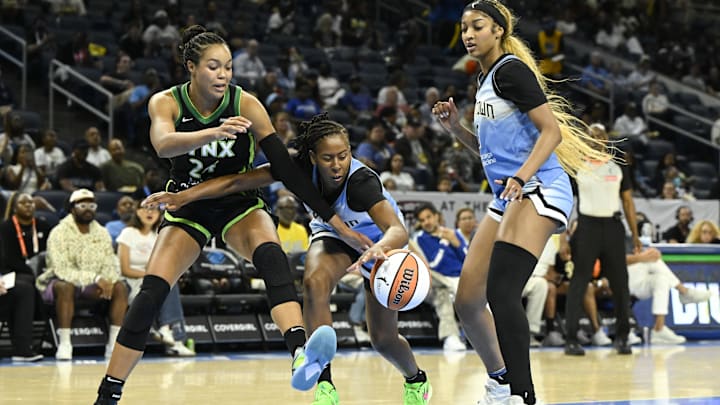 Jul 14, 2025; Chicago, Illinois, USA; Chicago Sky guard Ariel Atkins (7) grabs the ball from Minnesota Lynx forward Napheesa Collier (24) as forward Angel Reese (5) looks on during the first half at Wintrust Arena. Mandatory Credit: Matt Marton-Imagn Images Jul 14, 2025; Chicago, Illinois, USA; Chicago Sky guard Ariel Atkins (7) grabs the ball from Minnesota Lynx forward Napheesa Collier (24) as forward Angel Reese (5) looks on during the first half at Wintrust Arena. Mandatory Credit: Matt Marton-Imagn Images
